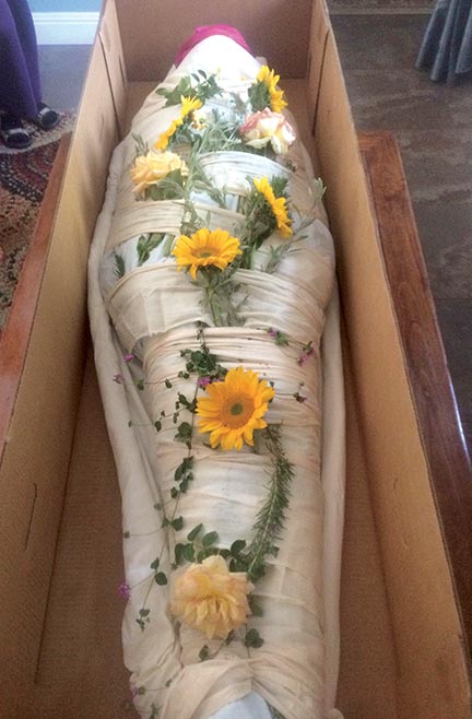 Body wrapped in cloth and flowers 