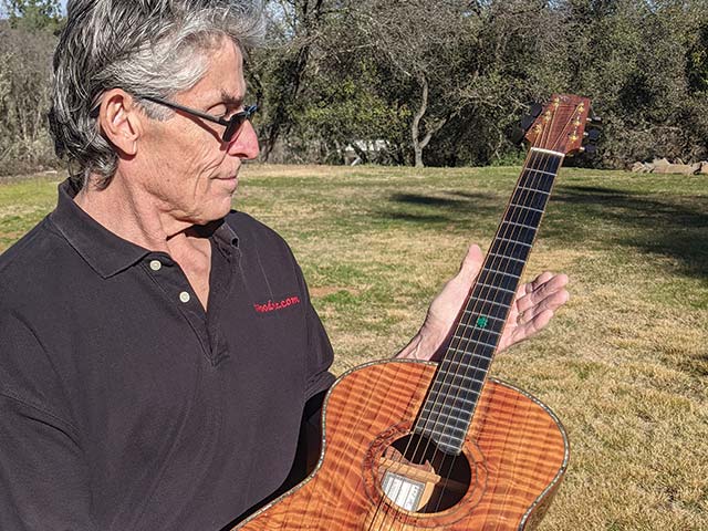 kimmes holds handmade guitar