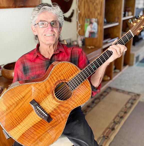 Kimmes holding handmade guitar