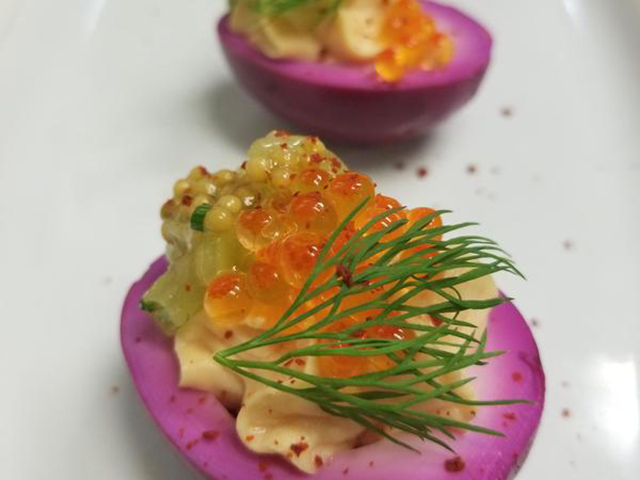 purple boiled egg halves topped with caviar