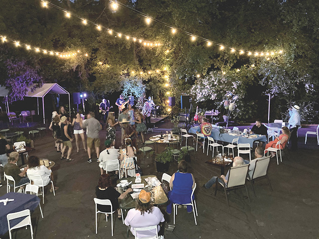 Wild Eye Pub's outdoor patio lively and lighted at night